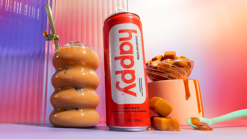 Can of 'happy' caramel latte with caramel syrup and caramelized donuts on a colorful background