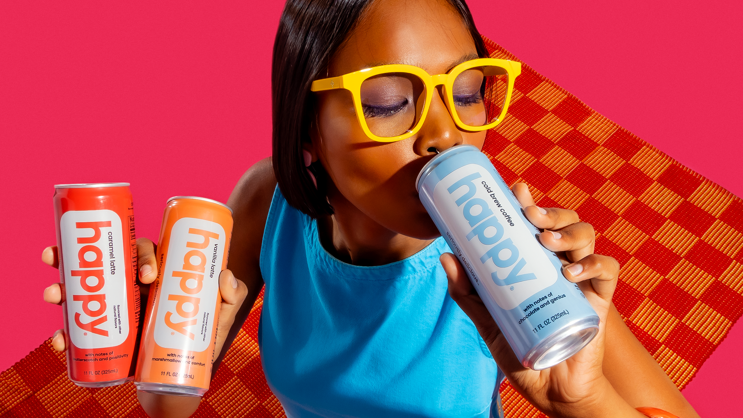 Person holding and drinking from happy cold brews and lattes with a colorful background