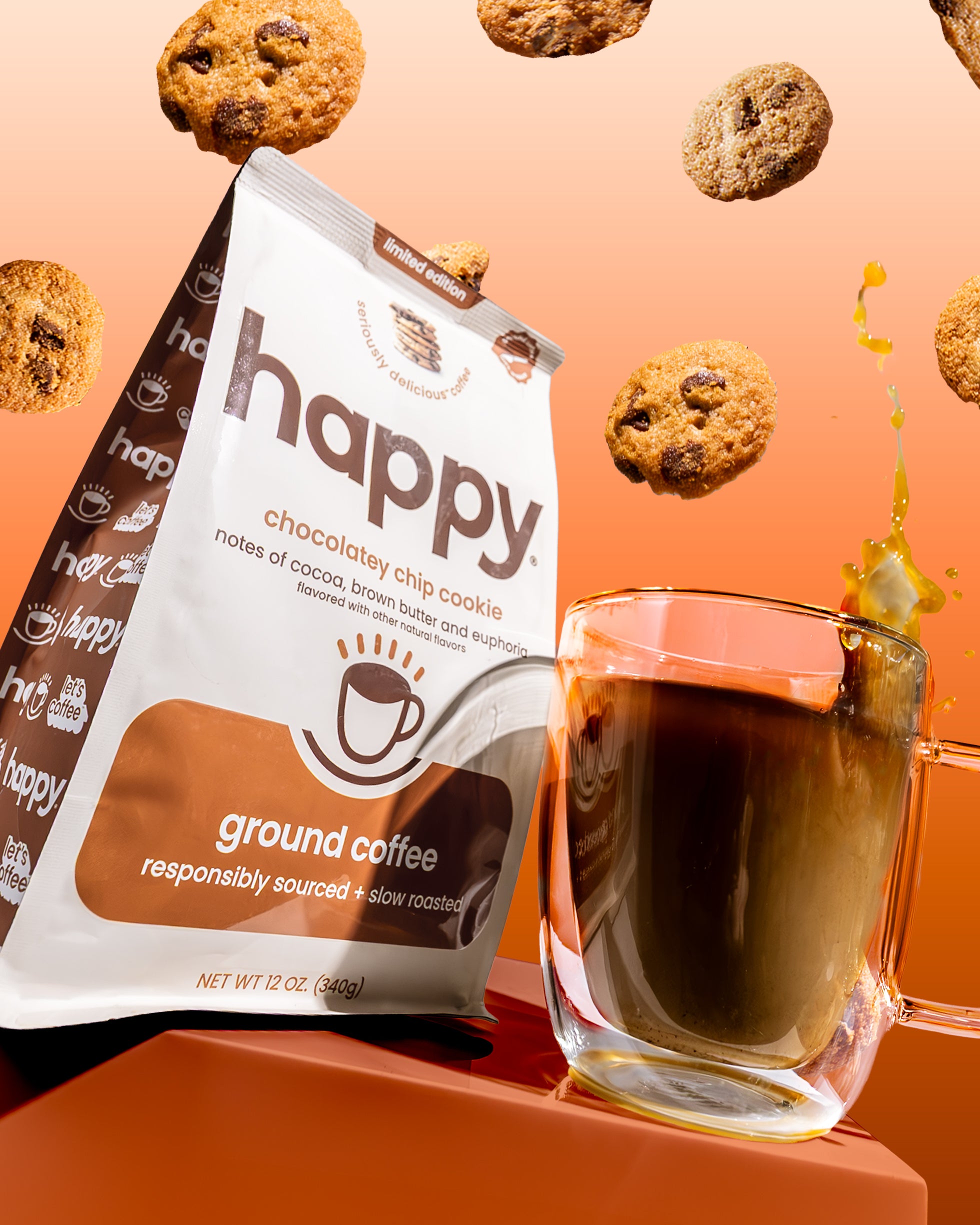 A bag of Happy Coffee Chocolatey Chip Cookie Ground Coffee with a coffee mug and cookies falling from the sky