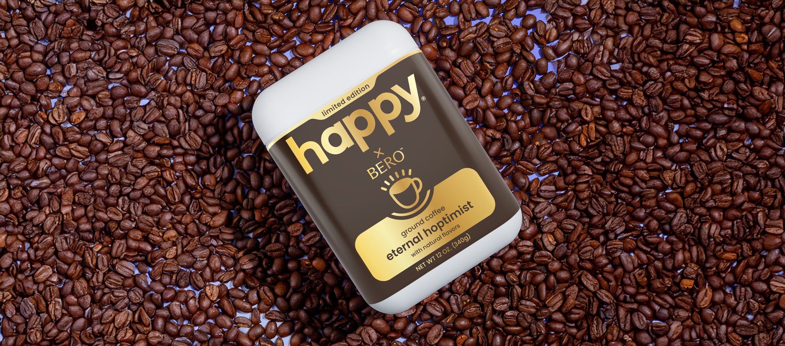 container of happy eternal hoptimist ground coffee on a bed of coffee beans