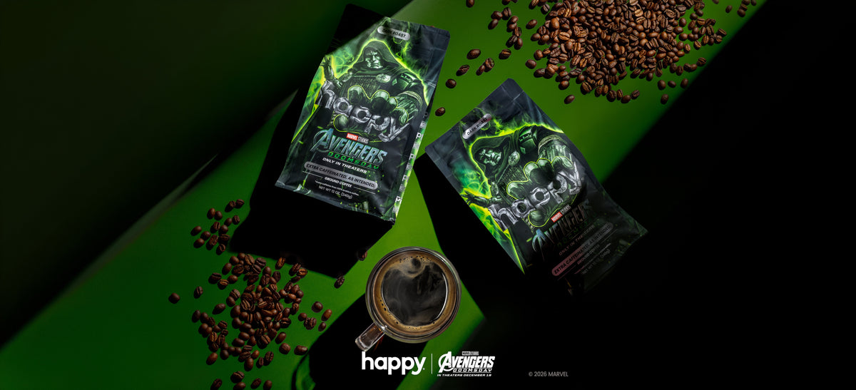 Two bags of ExtraCaffeinated Ground coffee Avengers Doomsday Cans on a green background with brewed coffee and coffee beans with the Happy x Avengers Doomsday Logos