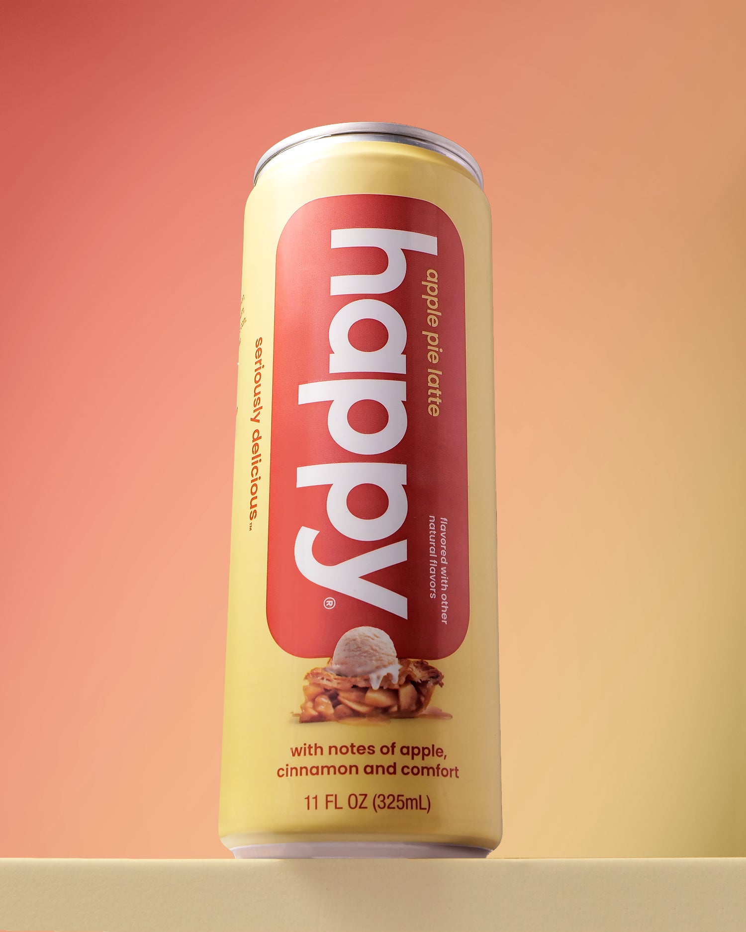 Can of 'happy' apple pie latte on a gradient background