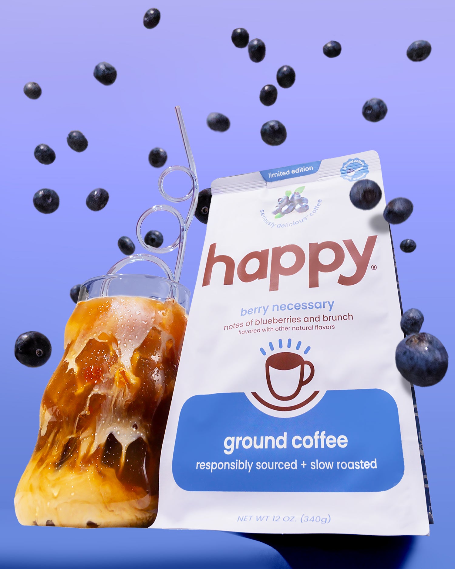 Happy ground coffee package with a glass of iced coffee and blueberries on a purple background
