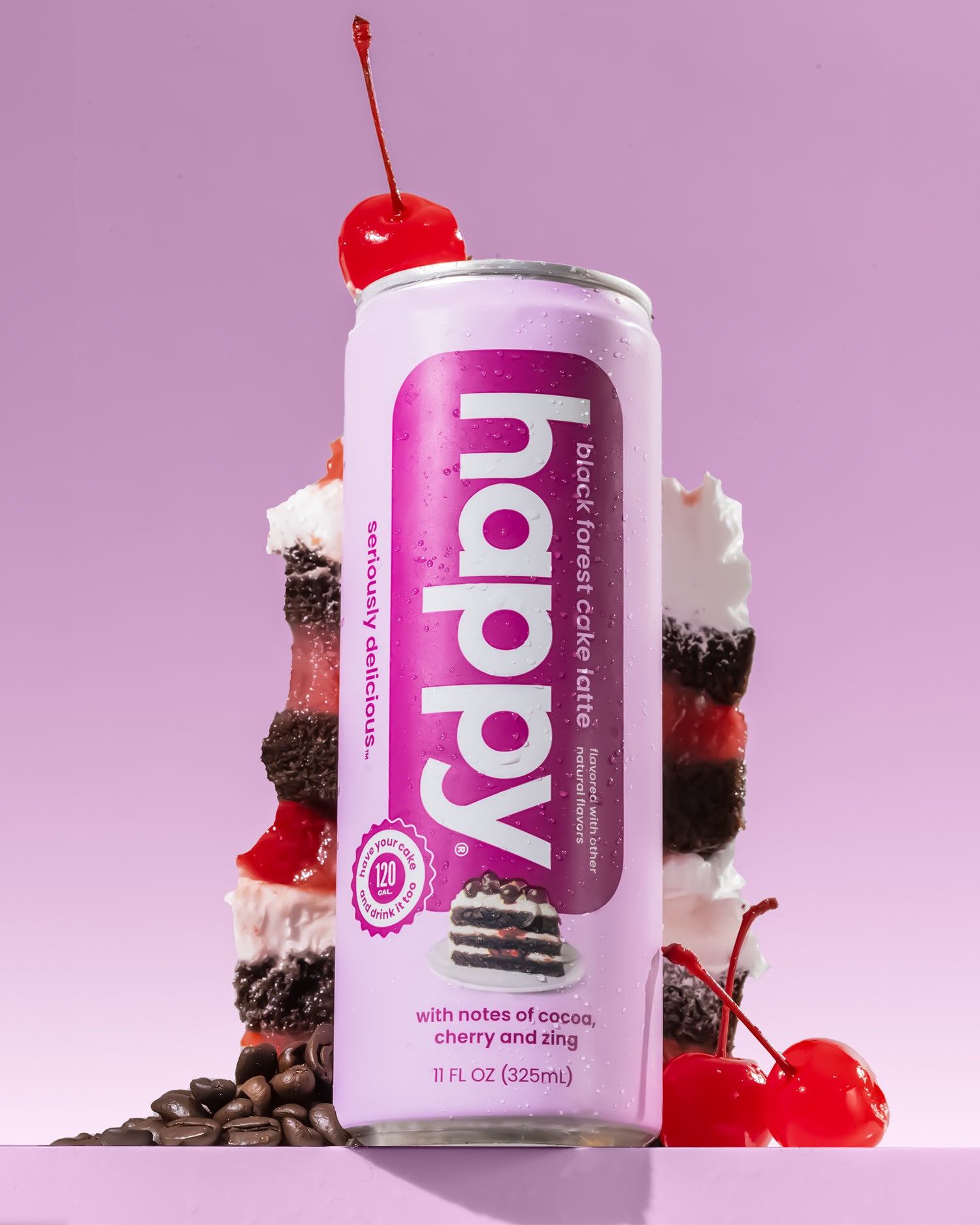 Can of 'happy' black forest cake latte with a cherry on top against a purple background
