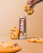 Can of 'happy' Chocolatey Chip Latte with chocolate chip cookies on a beige background