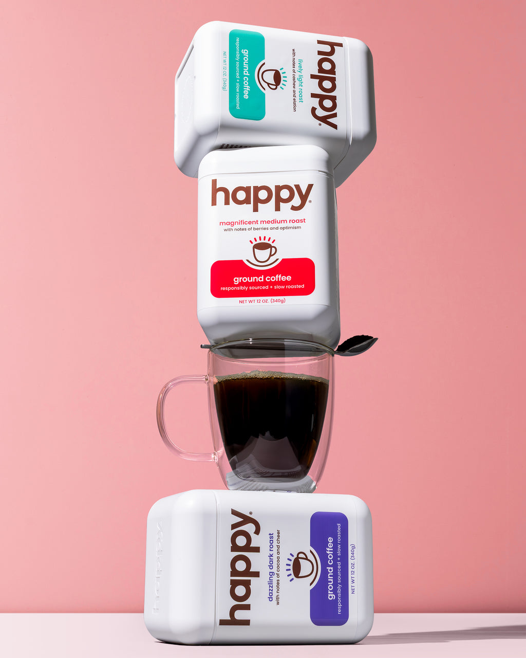 Happy coffee packaging with a cup of coffee on a pink background