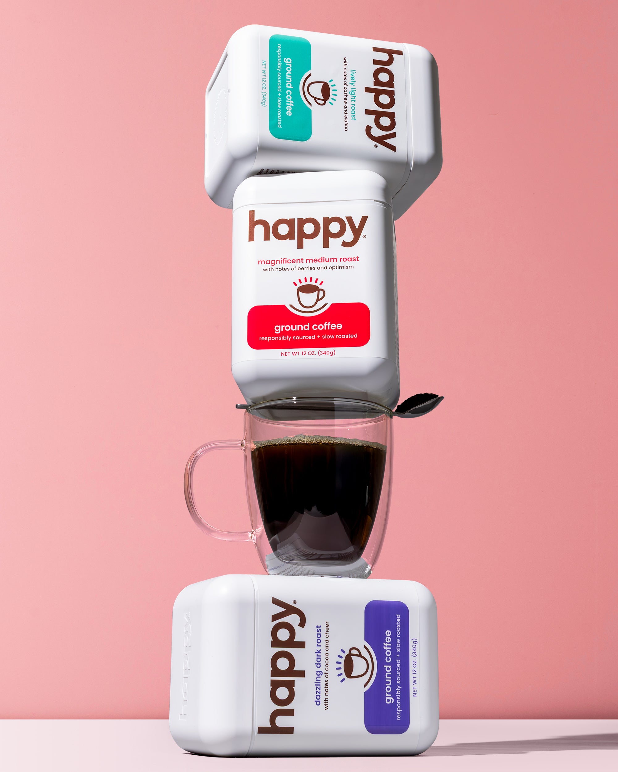 Happy coffee packaging with a cup of coffee on a pink background