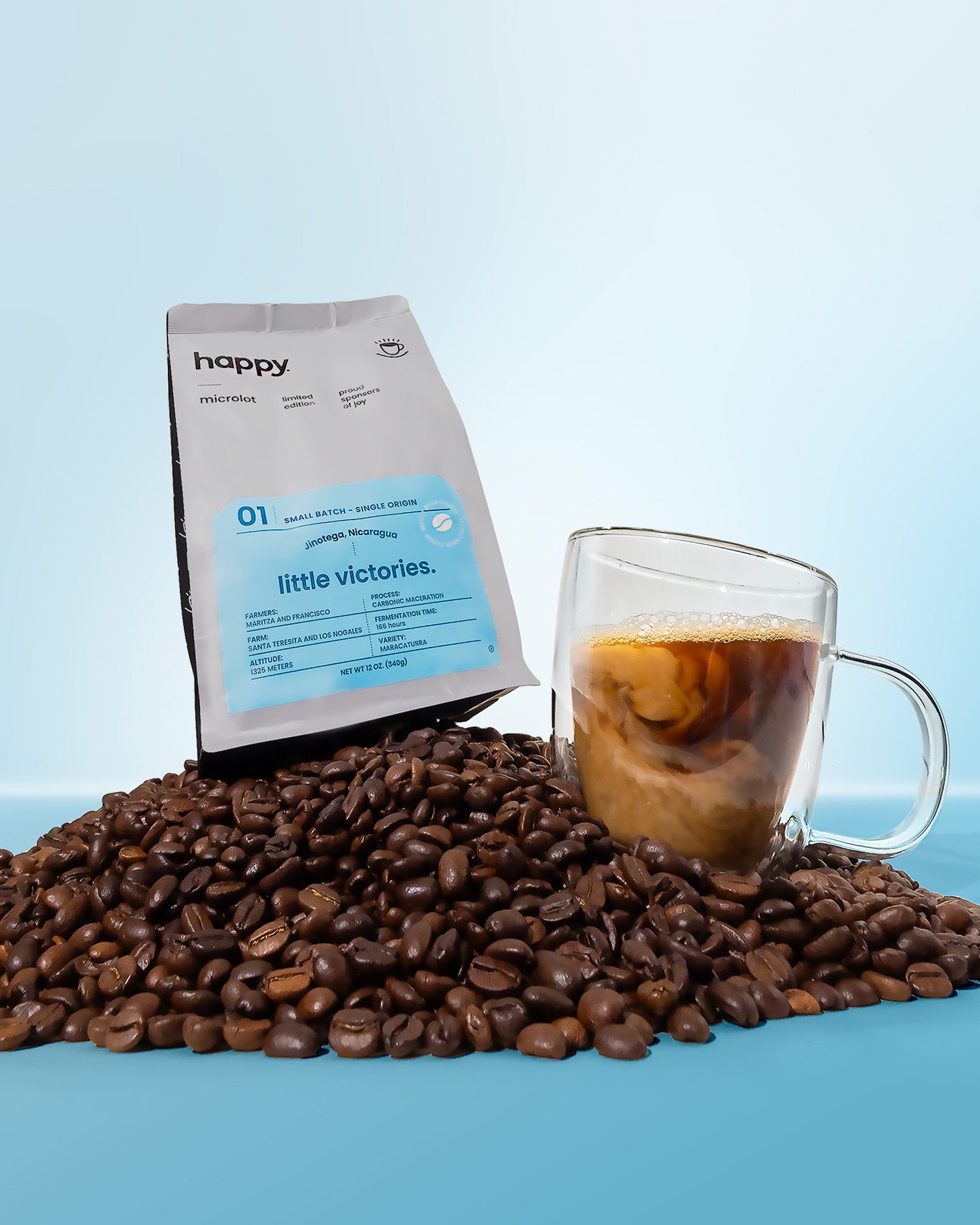 Happily roasted coffee beans with a glass of coffee and a bag of coffee on a blue background