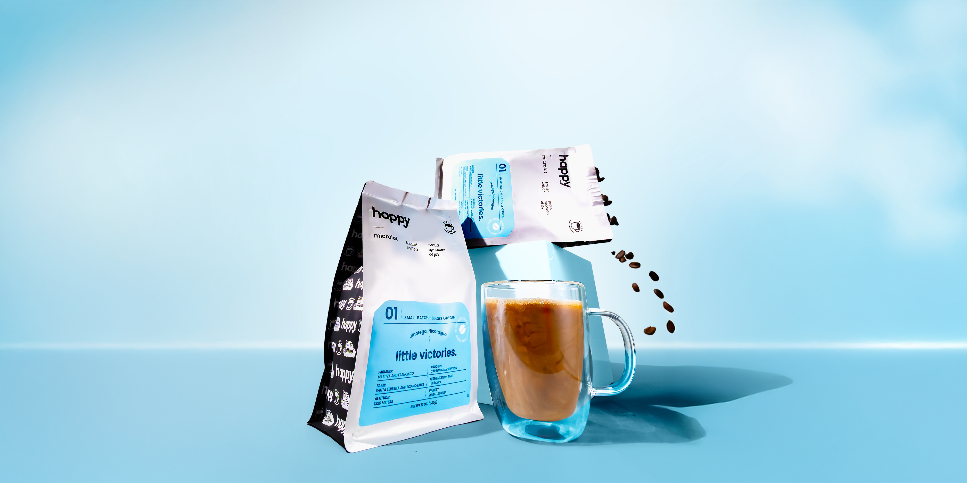 Little Victories Microlot High Quality Coffee Beans and cup on a light blue background
