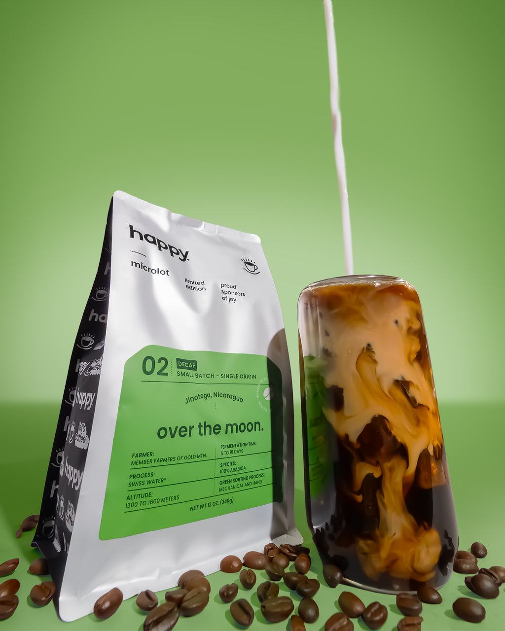 Over the Moon Decaf Coffee bag and Iced Coffee from happy on a green background