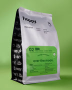 Over the Moon Decaf Coffee bag from happy on a green background