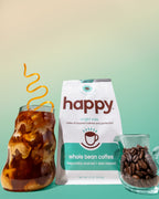 Iced coffee, Happy whole bean coffee package, and coffee beans on a gradient background