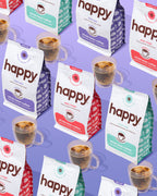 Multiple packages of 'happy' coffee with cups of coffee on a purple background