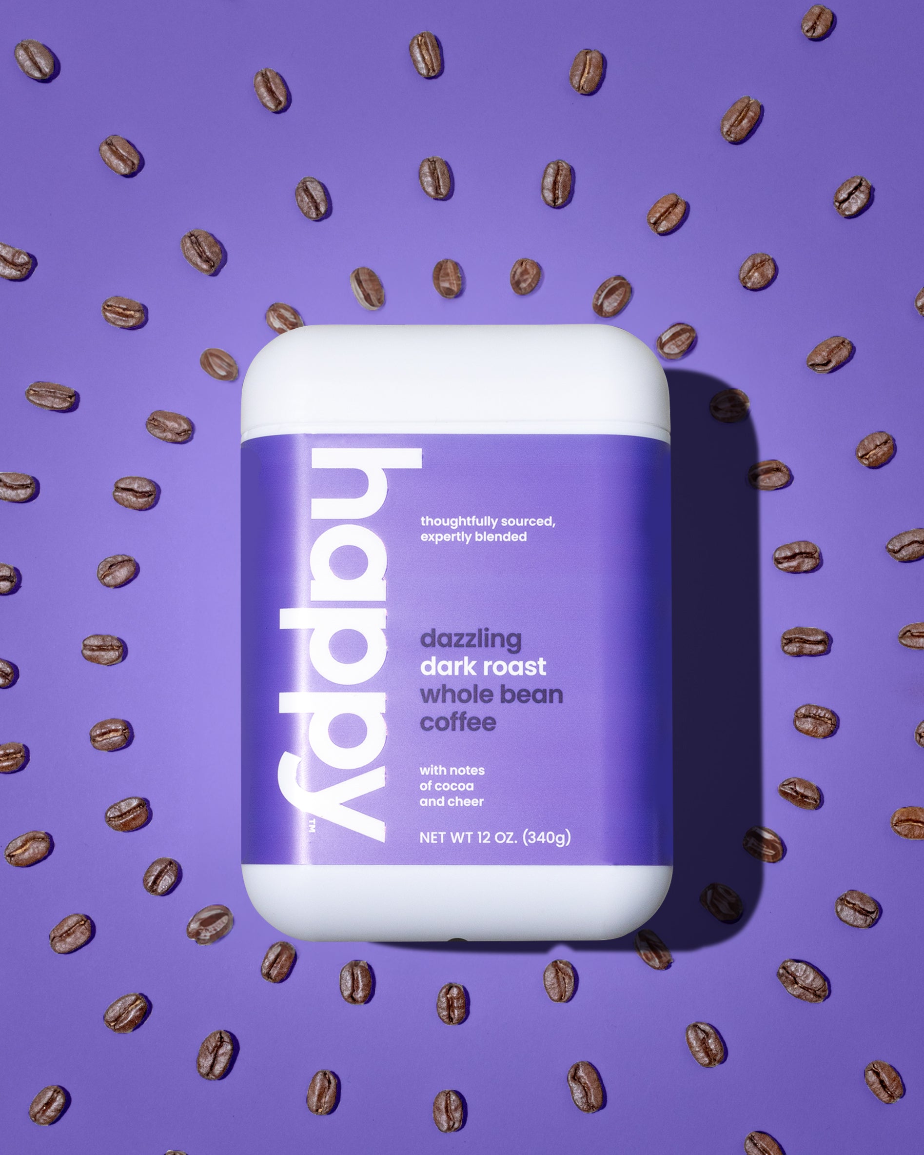 dazzling dark roast whole bean coffee on a purple background with coffee beans in a radiating pattern