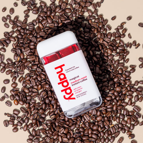 magical medium roast instant coffee container on a bed of coffee beans. 