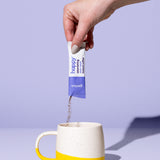a sachet of astonishing dark roast instant coffee being poured into a coffee mug