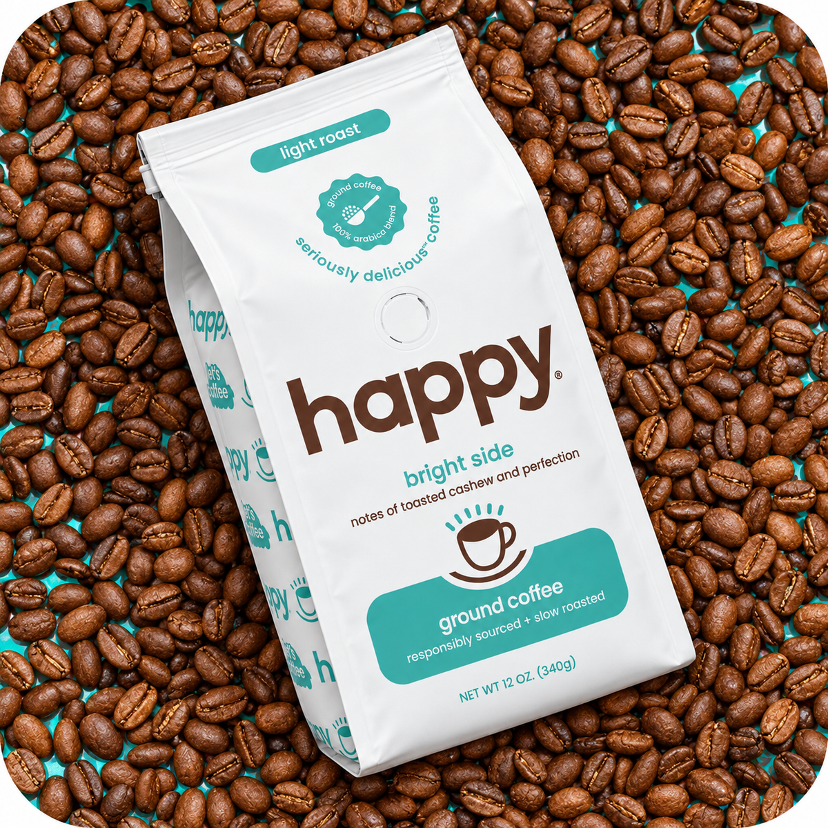 A white bag of Happy Bright Side light roast ground coffee, surrounded by scattered roasted coffee beans on a teal background.