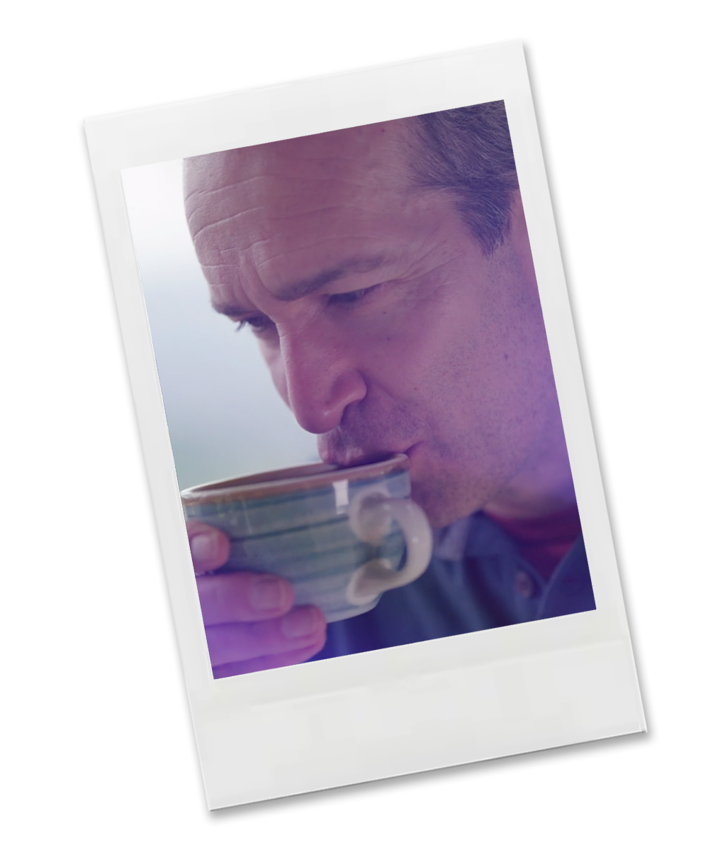 Polaroid-style photo of a man drinking from a cup on a white background