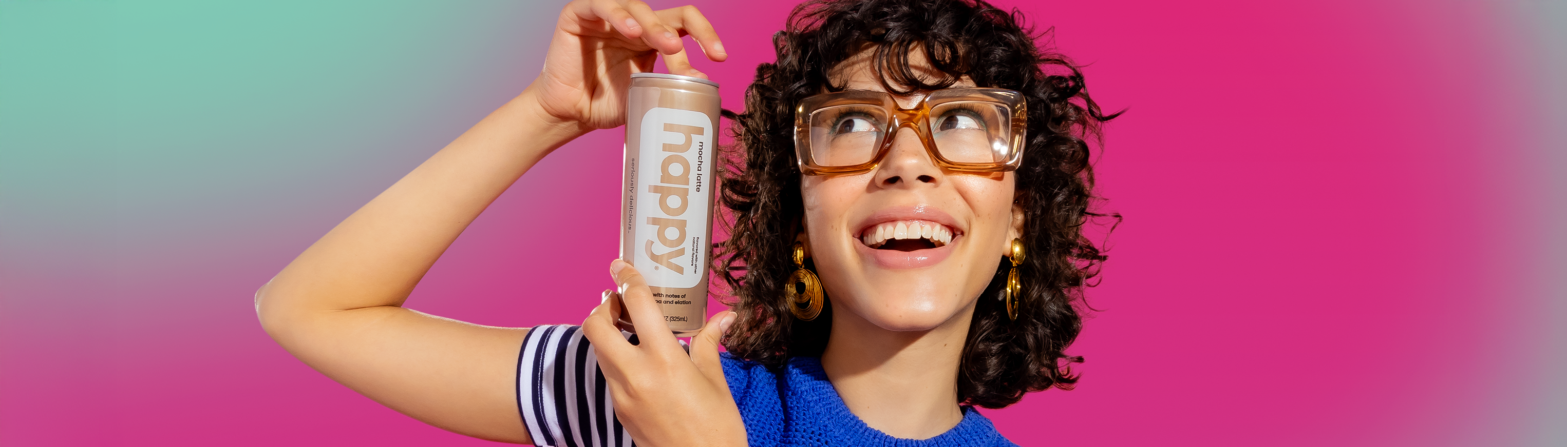 woman holding a cup of happy coffee with foam and caramel