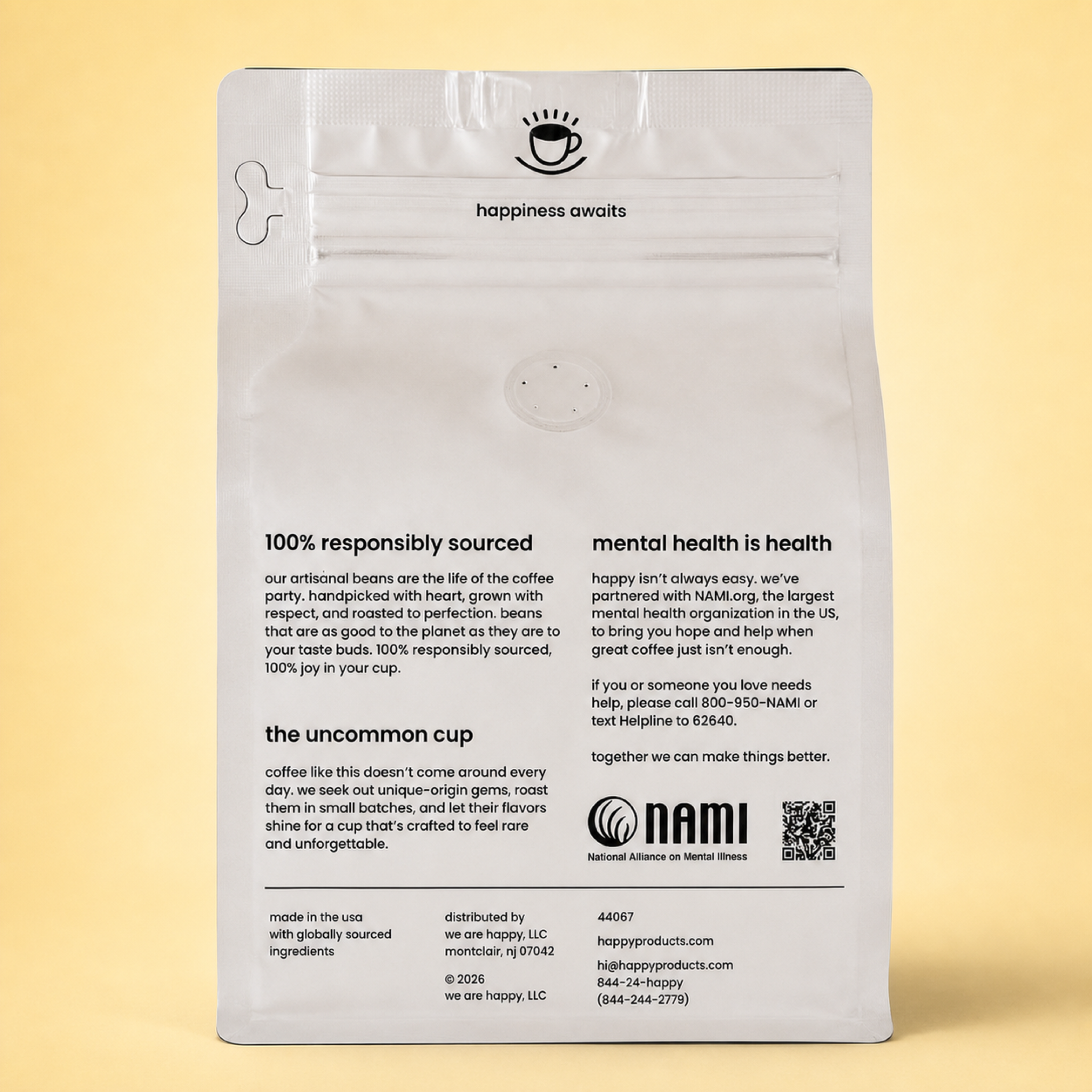 The back of a silver coffee of Cloud Nine Microlot Coffee from Happy Products, featuring product information, mission statement, and a QR code, set against a solid pale yellow background.